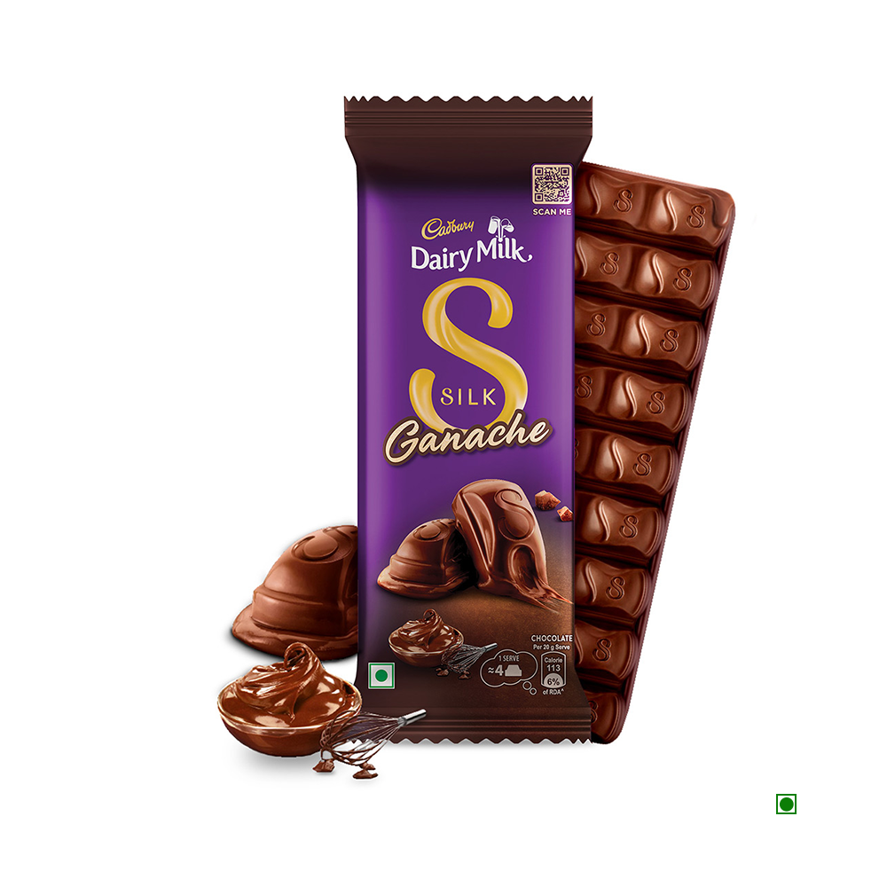 A partially unwrapped Cadbury Dairy Milk Silk Ganache Chocolate Bar 146g by Cadbury reveals creamy milk chocolate with a swirl of ganache, accompanied by a whisk—a delightful chocolate gift pack.