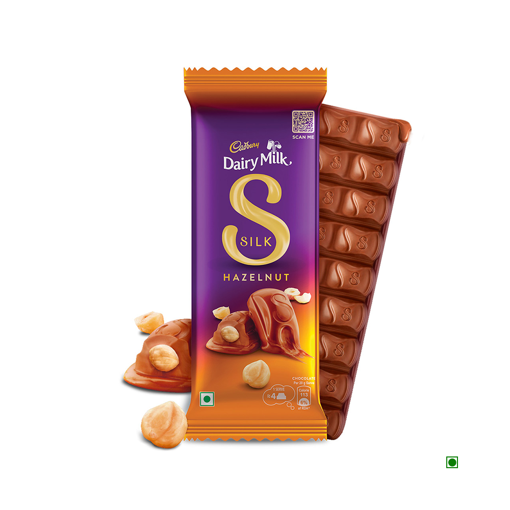 A partially unwrapped Cadbury Dairy Milk Silk Hazelnut Chocolate Bar 58g showcases delectable milk chocolate studded with whole Turkish hazelnuts.