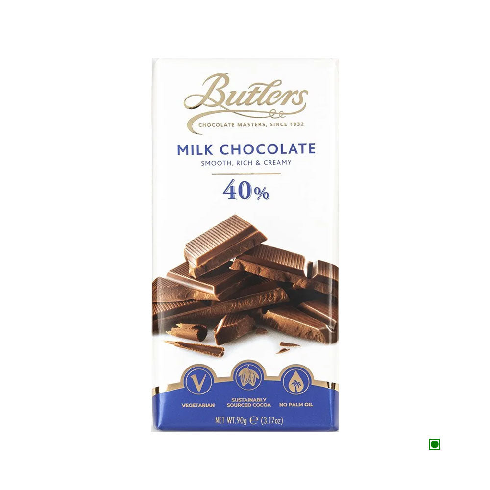 The packaging of the Butlers 40% Milk Chocolate Bar 90g highlights its creamy blend made with 40% cocoa content. It includes delicious milk chocolate pieces and bears labels for being vegetarian and made from sustainable cocoa. Crafted in Ireland, it has a net weight of 90g.