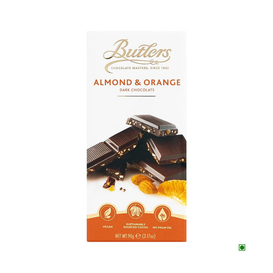 A 90g Butlers Dark Almond & Orange Bar, elegantly packaged and featuring a blend of almond and orange flavors, highlights its vegan-friendly credentials with sustainably sourced cocoa and is free from palm oil.