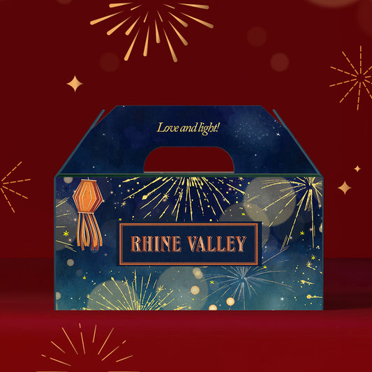 Decorative Rhine Valley Dragees Collection Box 400g featuring the text "Rhine Valley" and "Love and light!" on a festive red background adorned with fireworks, enriched with the rich aroma of pistachios.