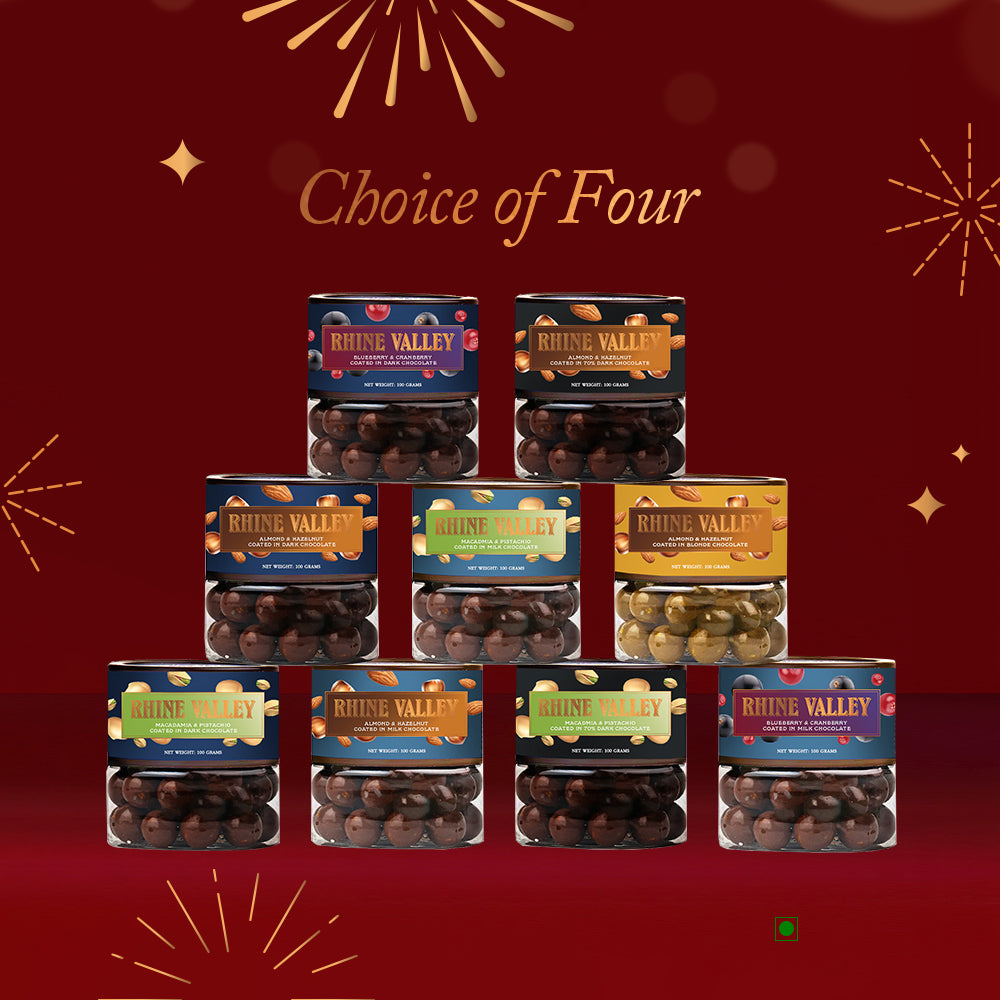 An assortment of Rhine Valley Dragees Collection Boxes, highlighted with white chocolate and pistachios, stacked in a pyramid against a red backdrop with the phrase "Choice of Four" displayed above.