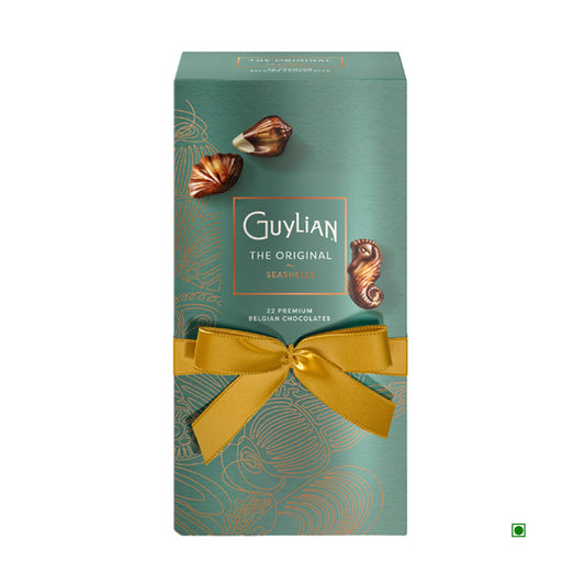 The Guylian Original Seashells Luxury Gift Box 250g is a collection of elegant seashell-shaped chocolates, elegantly presented in teal packaging with a shimmering gold ribbon.