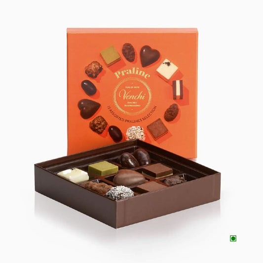 The Venchi Praline Gift Box 105g features an orange lid displaying assorted chocolate pieces and the word "Praline," emphasizing its Italian origin.