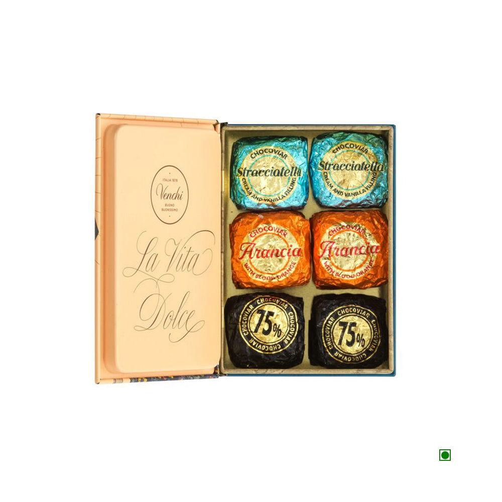 An open box of Venchi Vintage Mini Book Pack 119g chocolates, crafted in Italy, featuring Stracciatella, Arancia, and 75% cacao flavors. The decorative packaging includes "La Vita Dolce" on the inside lid.