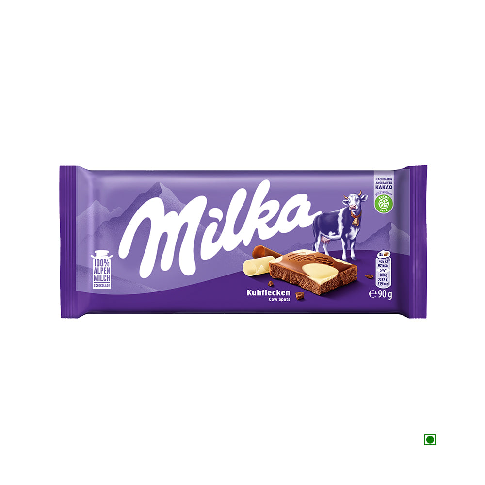 Milka Cow Spot Bar 90g by Milka comes in purple packaging with the iconic Alpine Cow and mountains, featuring milk and white chocolate pieces depicted on the wrapper.