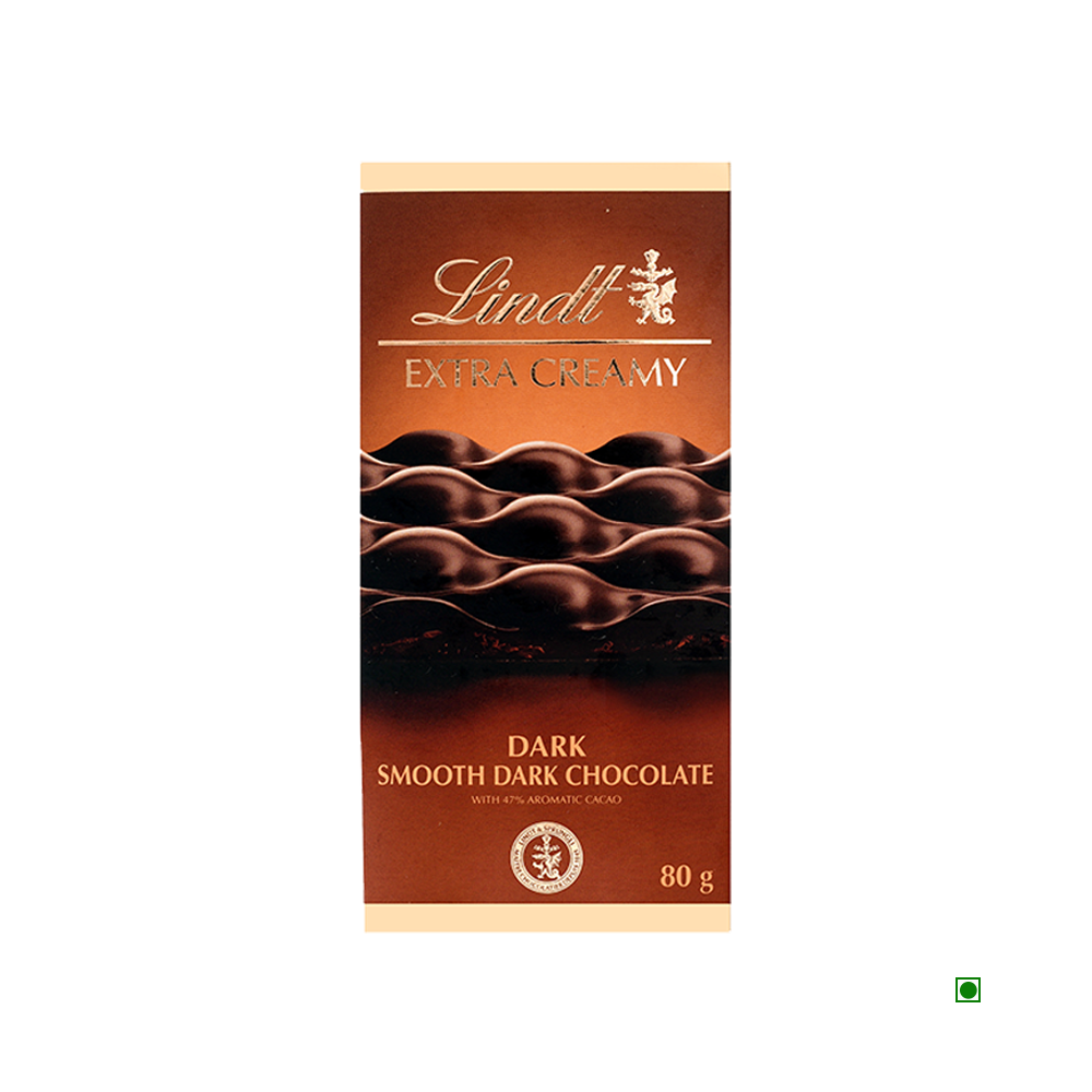 Front view of Lindt Extra Creamy Dark Tablet 80g, featuring a wavy chocolate design on the packaging; a smooth dark chocolate bar by Lindt, made in France.