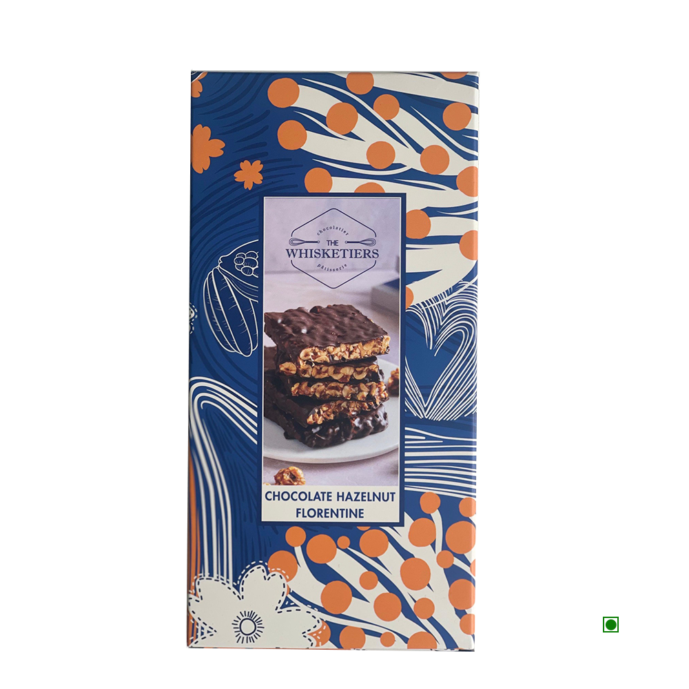 A 100g box of Whisketiers Hazelnut Dark Chocolate, featuring caramelised hazelnuts in dark chocolate with blue, white, and orange abstract packaging.