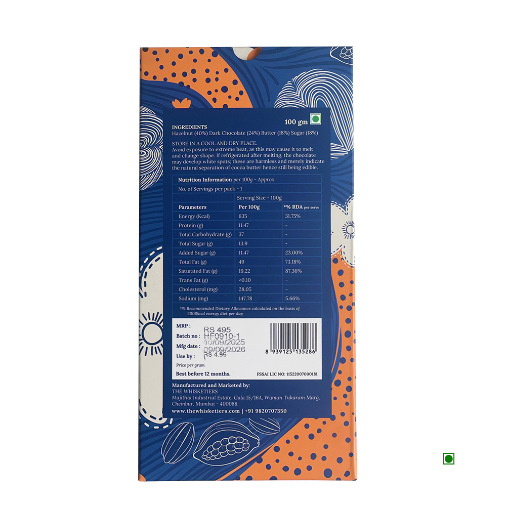 Back of The Whisketiers Hazelnut Dark Chocolate 100g bar by Whisketiers, showing ingredients like caramelised hazelnuts and dark chocolate, nutrition facts, price, manufacturer info, and storage advice on a blue and orange patterned background.