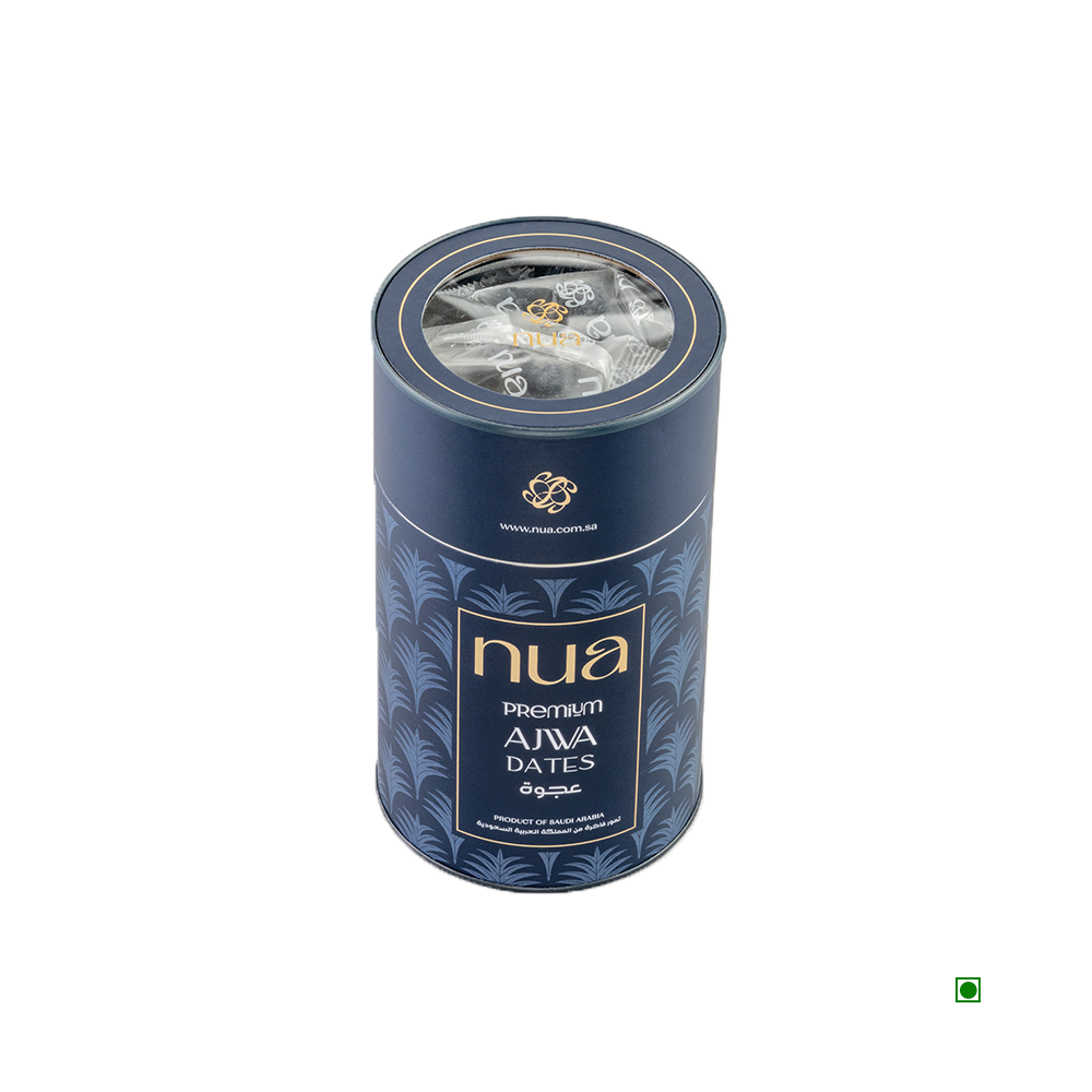 The Nua Ajwa Dates Cylinder 400g, branded by Nua, features a small transparent section revealing the luxurious contents inside, making it perfect for luxury gifting.