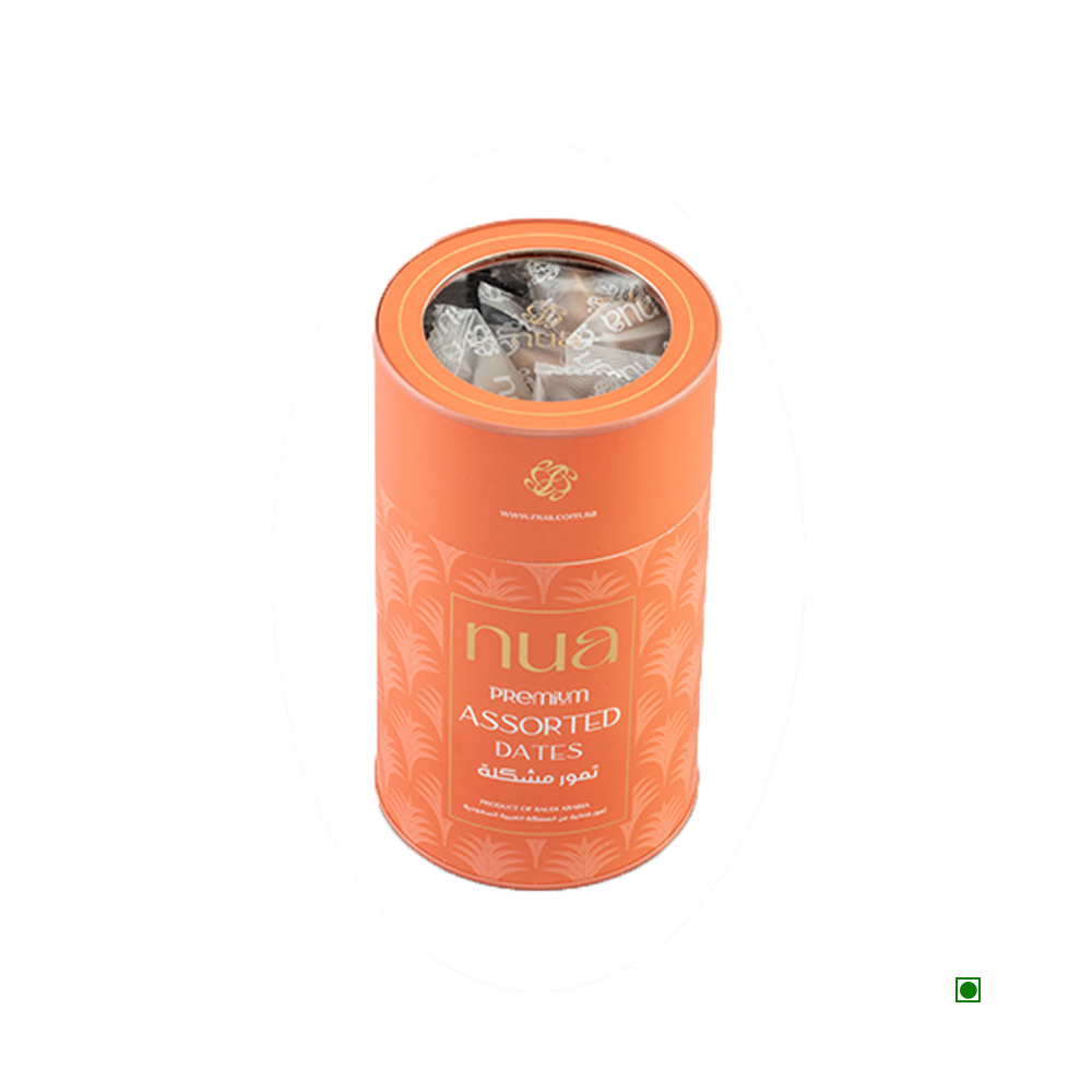 A cylindrical orange container labeled "Nua Mixed Dates Cylinder 400g" with a transparent top showing dates inside. Country of Origin: Saudi Arabia.