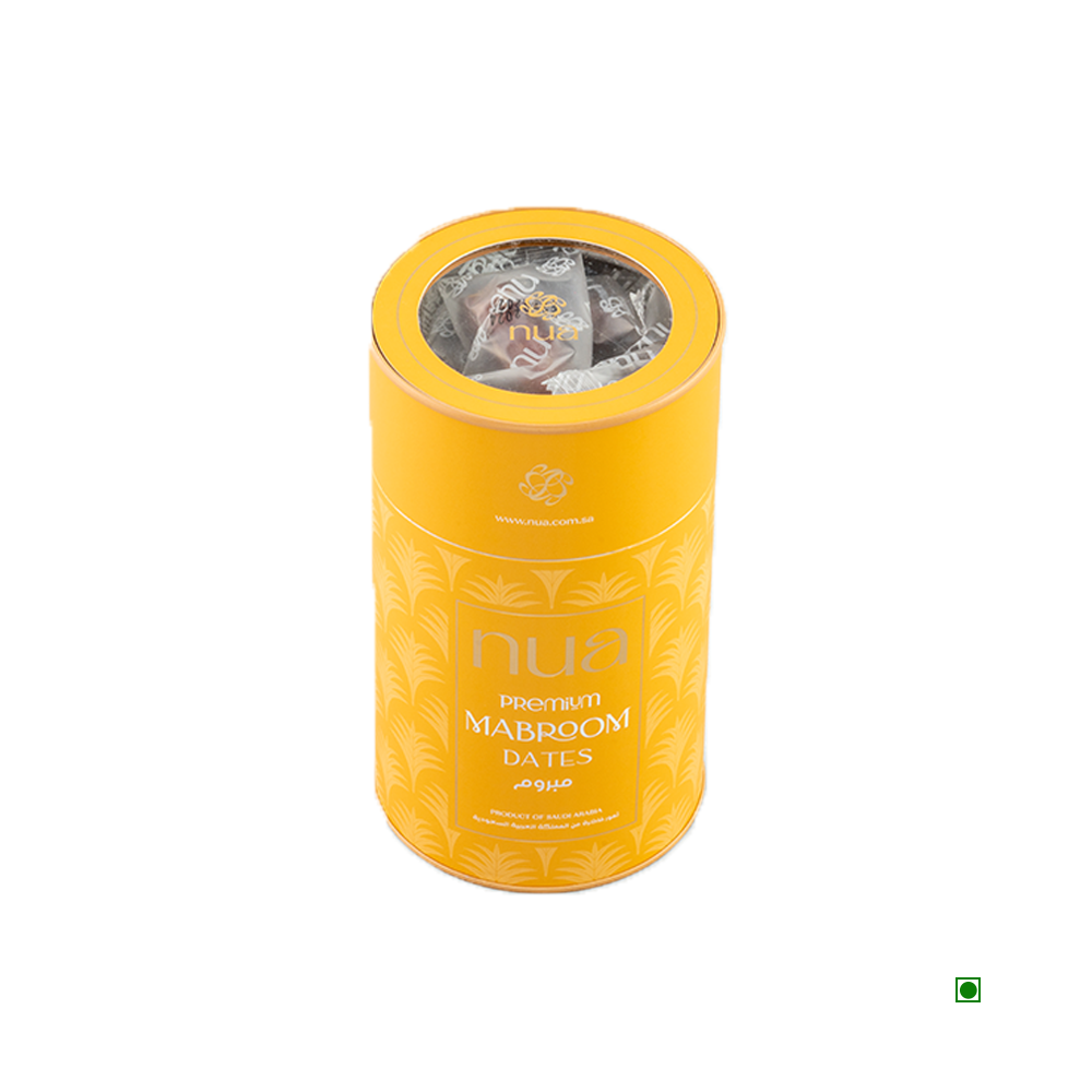 A cylindrical yellow container labeled "Nua Mabroom Dates Cylinder 400g," sourced from Saudi Arabia, with a transparent top showing the contents inside.