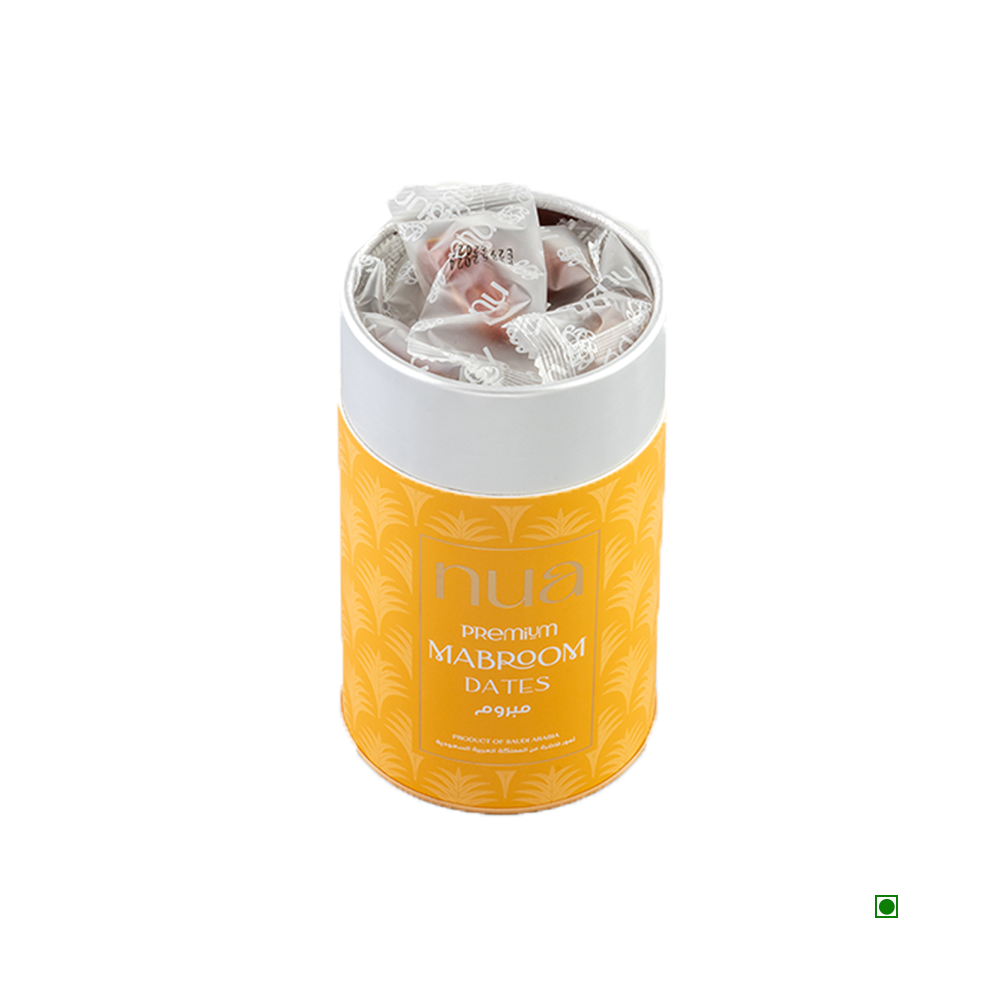 The Nua Mabroom Dates Cylinder 400g features premium Mabroom dates from Saudi Arabia, packaged in a yellow cylindrical container with a white lid. Each date is individually wrapped and can be seen through a transparent cover.