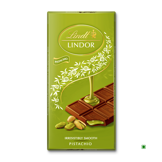 The Lindt Lindor Pistachio Tablet 100g features a green wrapper with images of Lindt milk chocolate squares, smooth pistachio LINDOR filling, and whole pistachios on the front.
