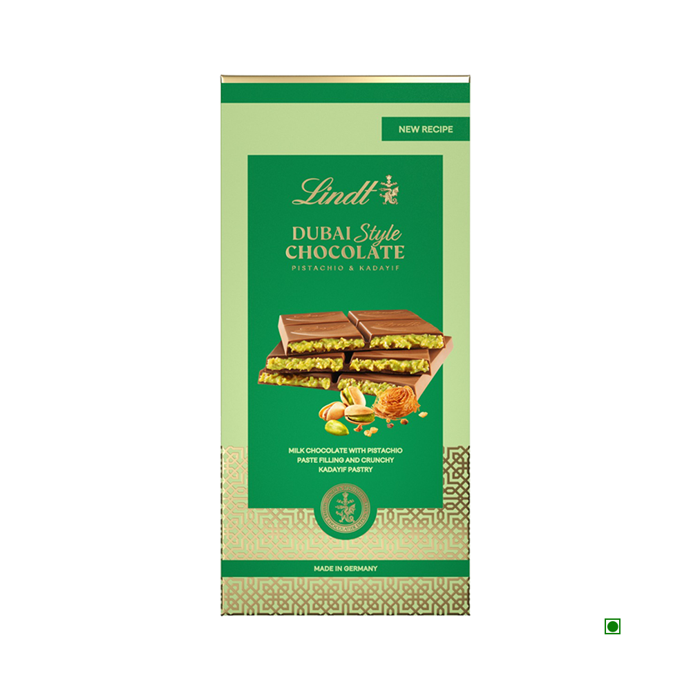 The Lindt Dubai Chocolate 145g bar is shown in green packaging with images of chocolate pieces, pistachios, and kadaifi pastry.