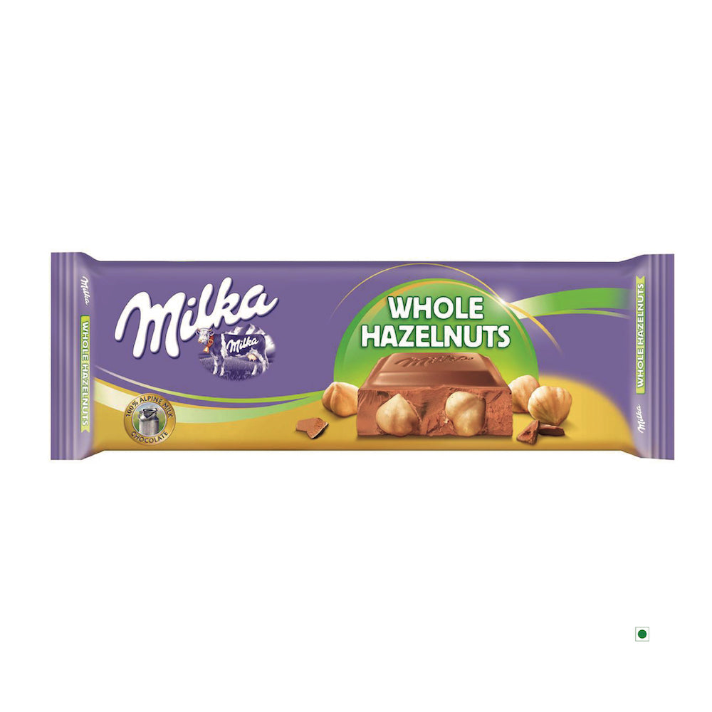 A Milka Whole Hazelnut Bar 270g, featuring Alpine milk chocolate with whole hazelnuts, packaged in its signature purple wrapper that showcases images of chocolate pieces and hazelnuts on the front.