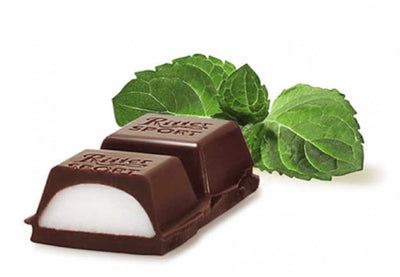 A Ritter Sport Peppermint Bar 100g with a mint leaf next to it.