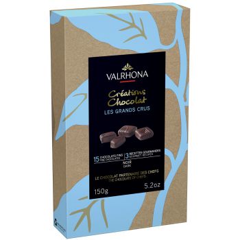 A box of Valrhona Coffret Grand Crus Milk & Dark 15pc Gift Box 150g with a leaf on it.
