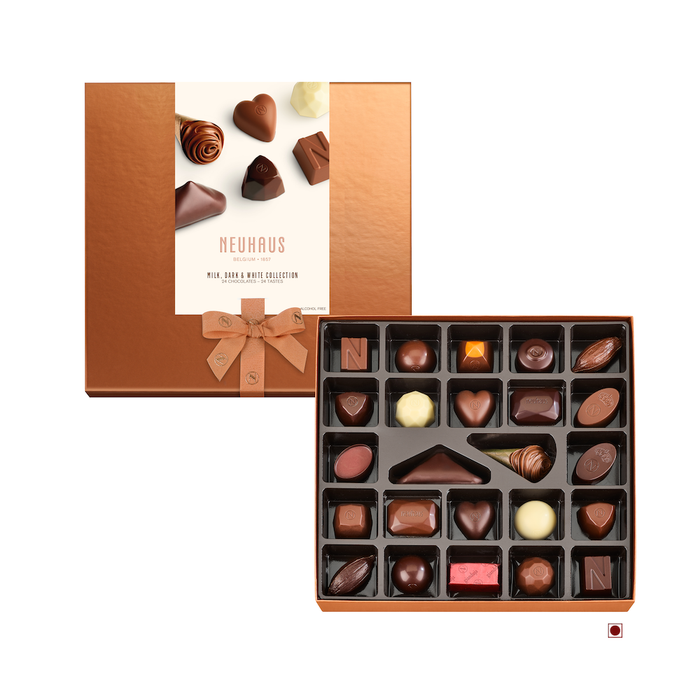 The open gift box unveils an assortment of chocolates from the Neuhaus Diwali: Milk, Dark & White Collection 24pc 266g. This elegant presentation includes a variety of shapes and decorations, completed with a bronze lid and a neatly tied bow.