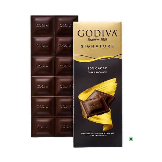 A Godiva Dark 90% Bar 90g is partially unwrapped, showcasing the luxurious chocolate squares within, skillfully crafted in Belgium by the renowned brand Godiva.