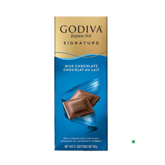 The packaging of the Godiva Milk Chocolate Bar 90g beautifully captures the essence of Belgium, featuring two indulgent chocolate squares set against a calming blue backdrop.