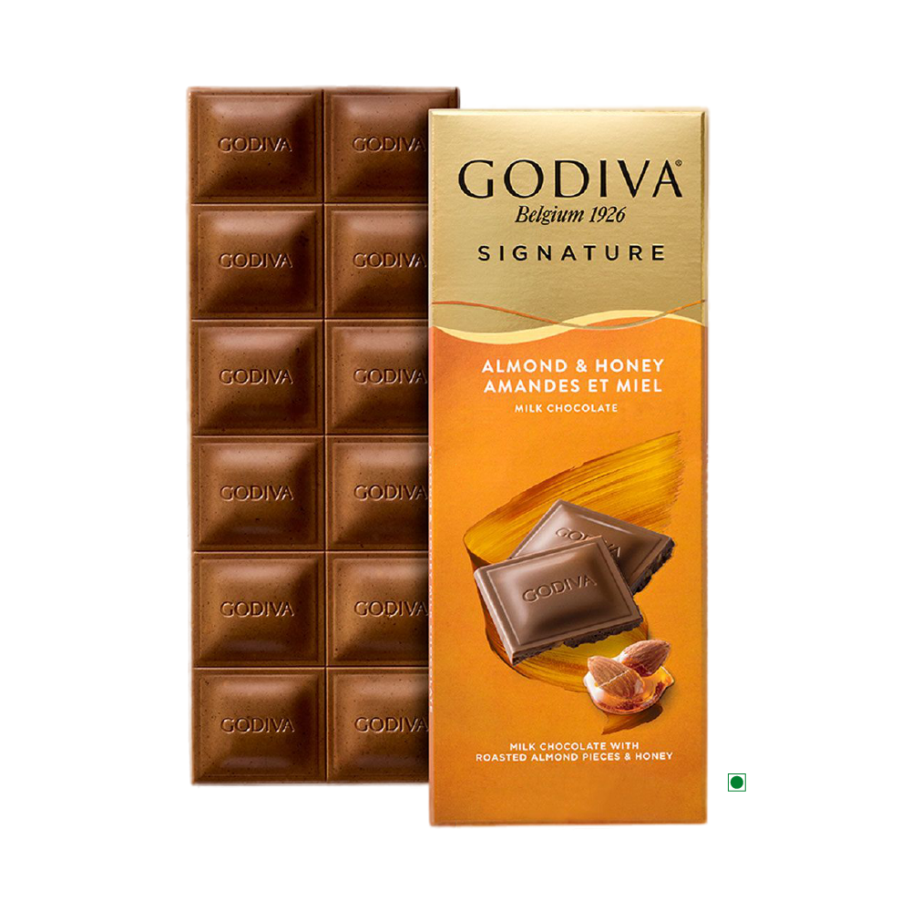 The Godiva Milk Honey Almond Bar 90g, crafted by the renowned brand Godiva, offers a delightful combination of milk chocolate infused with roasted almonds and honey, beautifully packaged with enticing images of chocolate pieces and almonds.