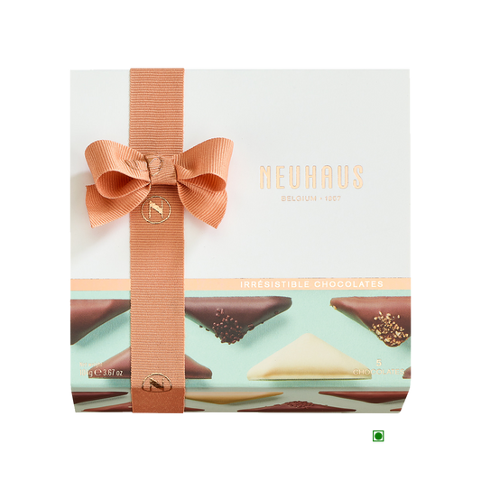 A box of Neuhaus Discovery Irresistibles 104g chocolates with a bow on top.
