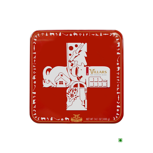 A Villars Milk Napolitains Tin Box 400g with an image of a cross on it.