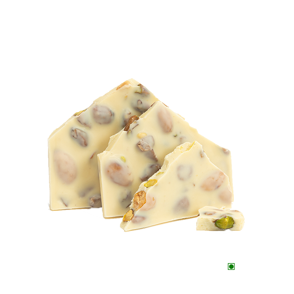 A piece of Rhine Valley White Fruit & Nut 100g with pistachios and nuts.