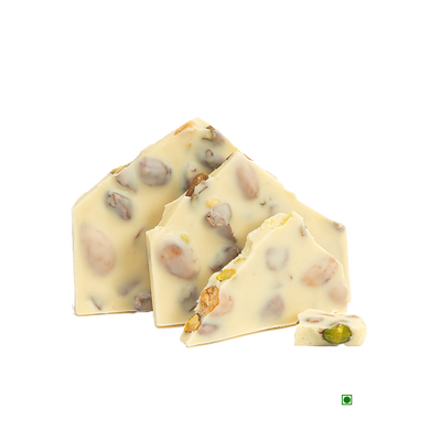 A piece of Rhine Valley White Fruit & Nut 100g with pistachios and nuts.