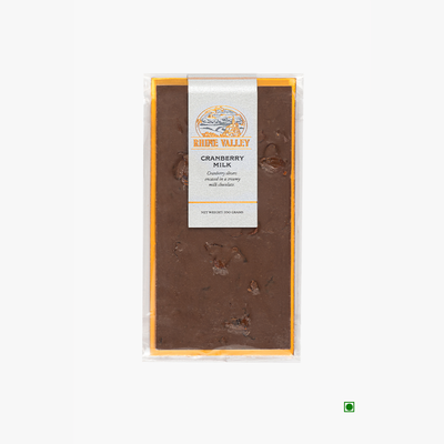 A Rhine Valley Cranberry Milk 100g chocolate bar with cranberry slivers in a package on a white background.