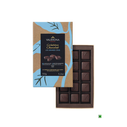 A Valrhona Coffret Grand Crus Milk & Dark 15pc Gift Box 150g with a leaf on it.