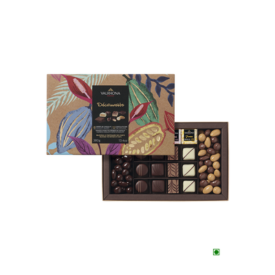 An open gift box of Valrhona Discovery Milk, Dark & White chocolates with a variety of shapes and shades, accompanied by its elegantly designed recyclable packaging.
