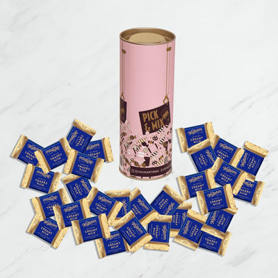 A tin of Pick & Mix : Whittakers Loose Creamy Milk Squares 100/200gm chocolates on a marble table.