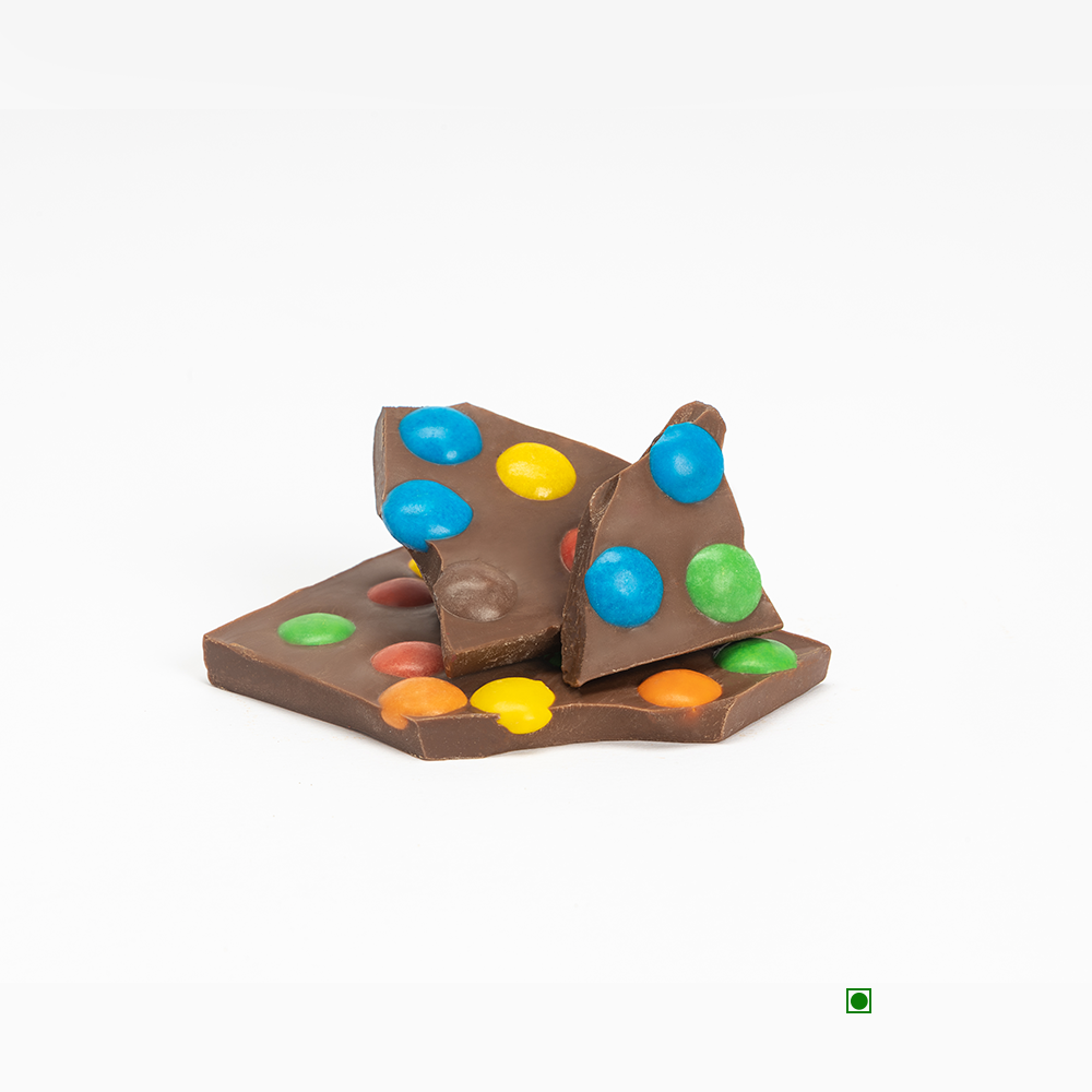A piece of chocolate covered in Rhine Valley M&M Milk Crunch 100gm.