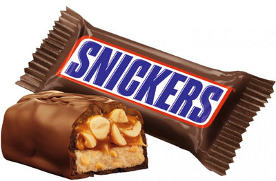 A Snickers chocolate candy bar, Snickers, with a peanut on it.
