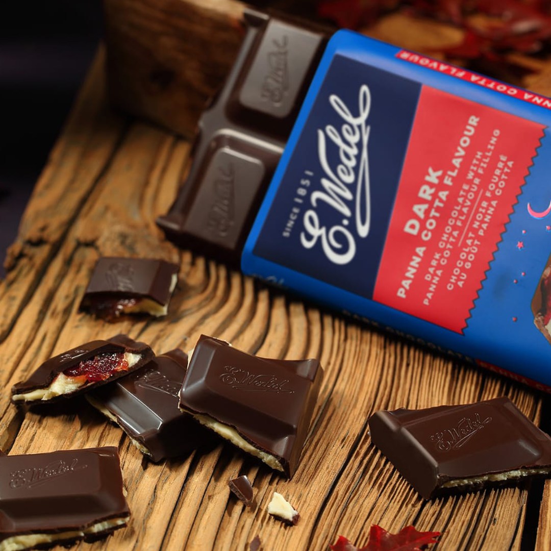 Wedel's Wedel Dark Chocolate With Panna Cotta Filling Bar 100g on a wooden table.