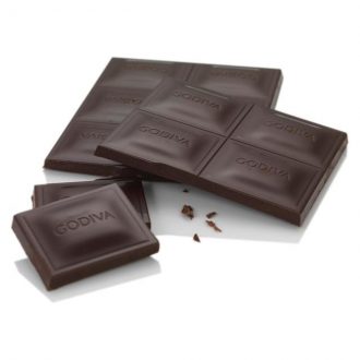 A Godiva Dark 72% Bar 90g with a piece of chocolate on it.