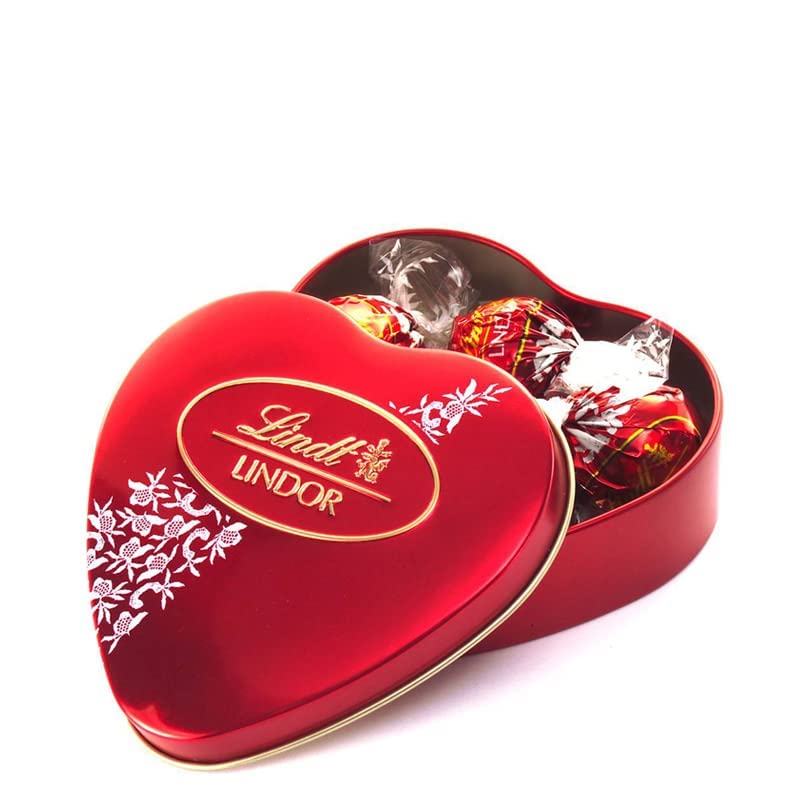 A red Lindt Lindor Armour Heart Milk Truffle Box 62.5g filled with Lindt milk chocolate truffles.