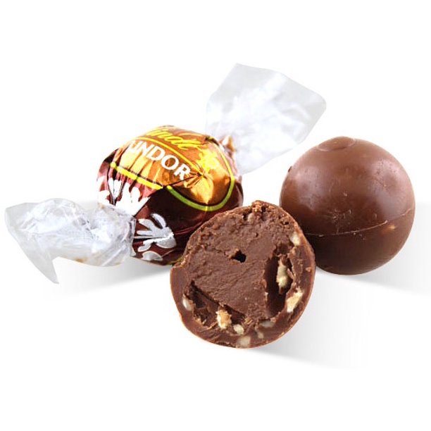 A Lindor Hazelnut 100/250/500g chocolate ball next to a piece of Lindt chocolate wrapper.