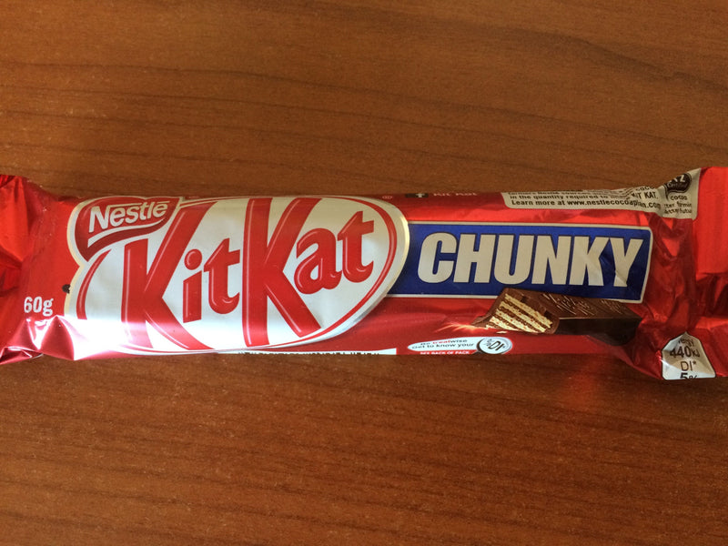 A wrapped Kit Kat Chunky Milk Bar 40g on a wooden surface.