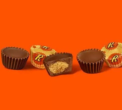 Hershey's Reese Peanut Butter Cup Bag 298g on an orange background.