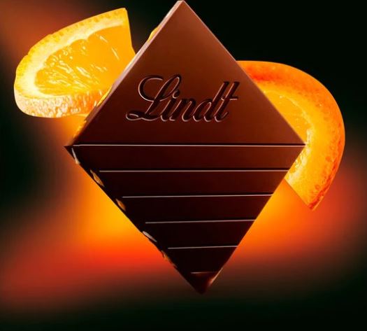 A Lindt Excellence Orange Intense Bar 100g with orange slices on it.