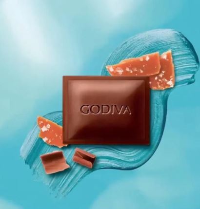 Godiva Milk Salted Caramel Bar 90g on a blue background.