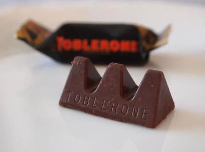 A Toblerone Tiny Dark Bag 272g with the word tolstoy on it.
