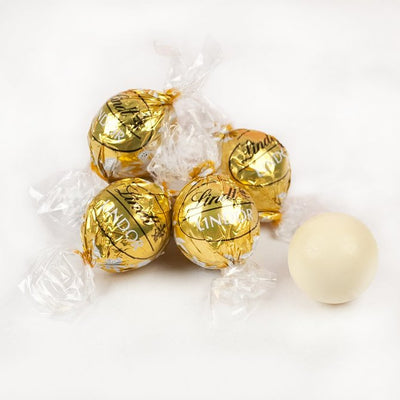 A group of Pick & Mix : Lindor White 100/250/500g chocolates with a white ball in the middle.