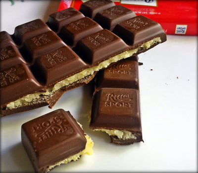 A Ritter Sport Marzipan Bar 100g with a piece cut out of it.