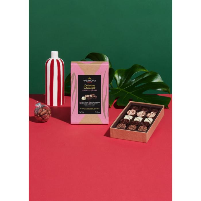 A Valrhona Petits Delices Milk, Dark & White 15pc Gift Box 145g on a red background.